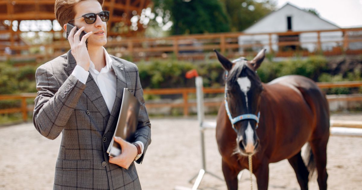 "Equestrian property for sale with horse stables, riding arena, and spacious countryside land."