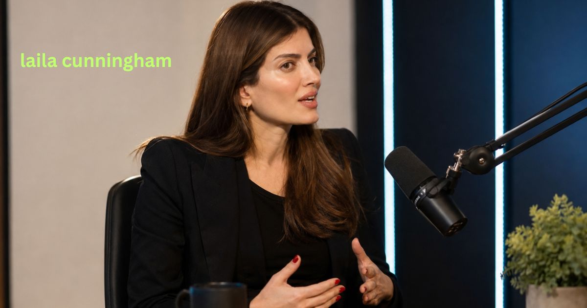 Laila Cunningham speaking during a studio podcast interview in a dark blazer