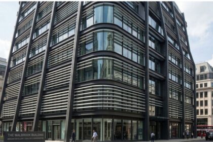 The Walbrook Building, a modern office building in central London with glass façades, pedestrians, and red double-decker buses.