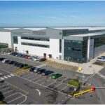 Aerial view of a large commercial logistics building and car park at Fradley Park, Staffordshire.