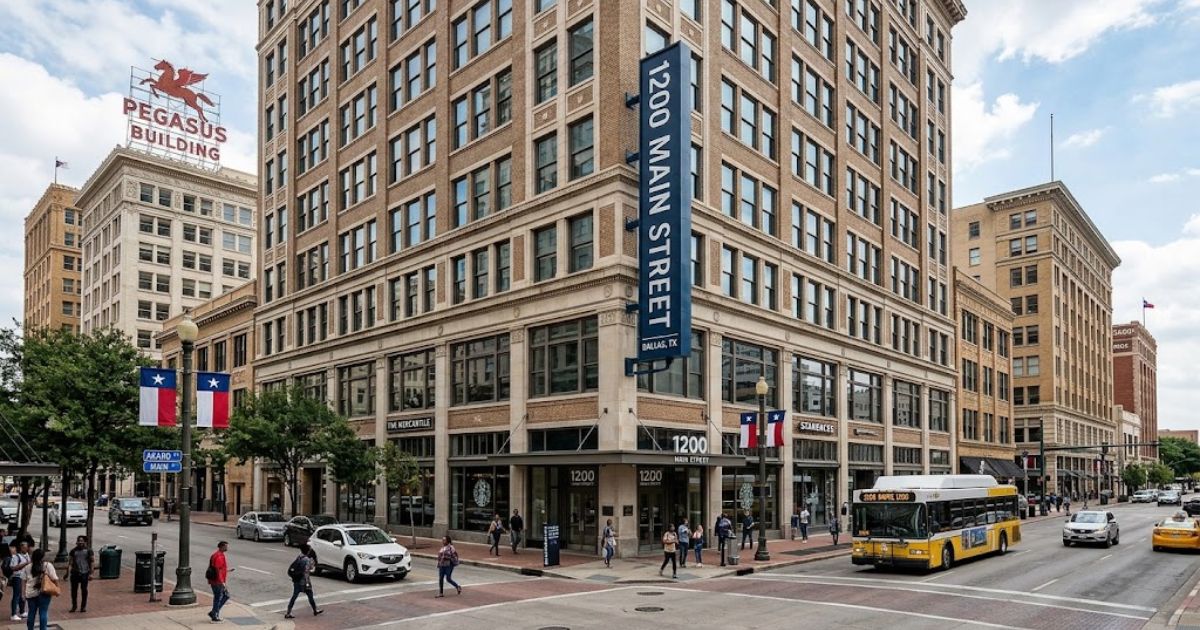 1200 Main Street Dallas historic brick building with pedestrians, city streets, and public transit.
